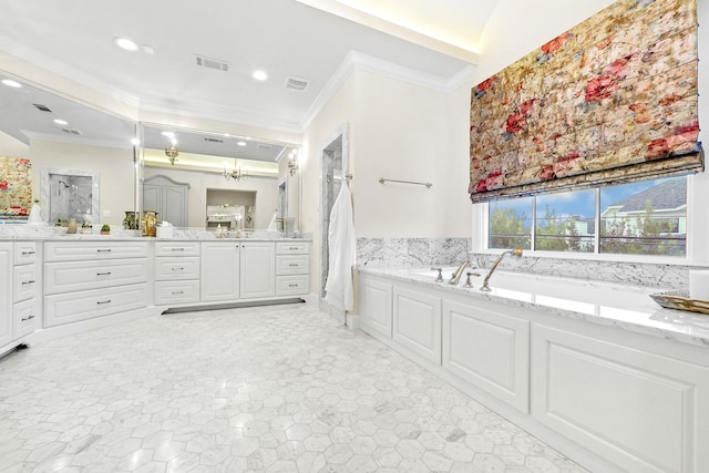 bathroom with vanity, a tub to relax in, and crown molding