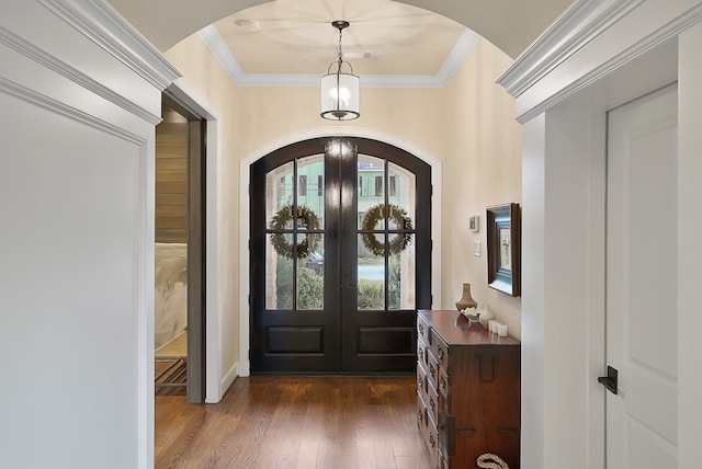 foyer featuring french doors, dark hardwood / wood-style flooring, and ornamental molding