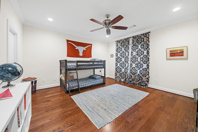 bedroom with hardwood / wood-style floors, ceiling fan, and crown molding