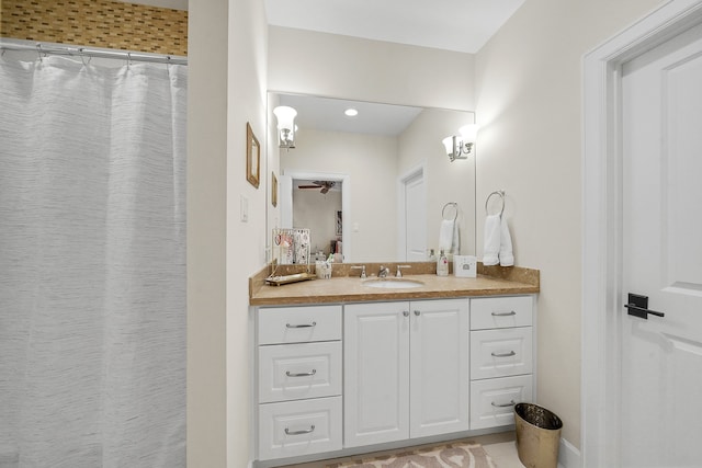 bathroom featuring curtained shower, tile patterned flooring, vanity, and ceiling fan