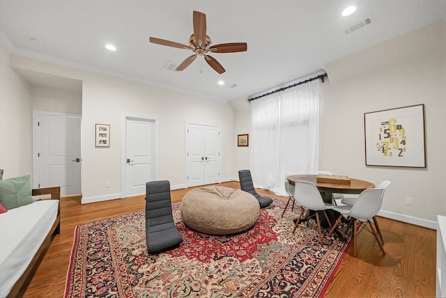 living room with hardwood / wood-style flooring and ceiling fan