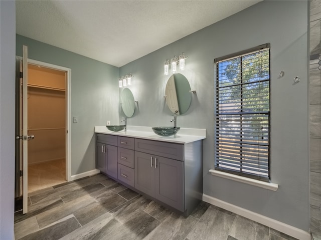 bathroom featuring hardwood / wood-style floors, vanity, and a textured ceiling