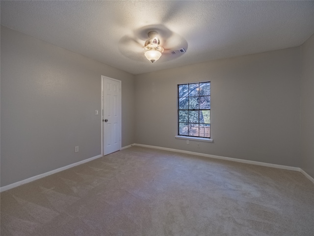 empty room with carpet flooring, a textured ceiling, and ceiling fan