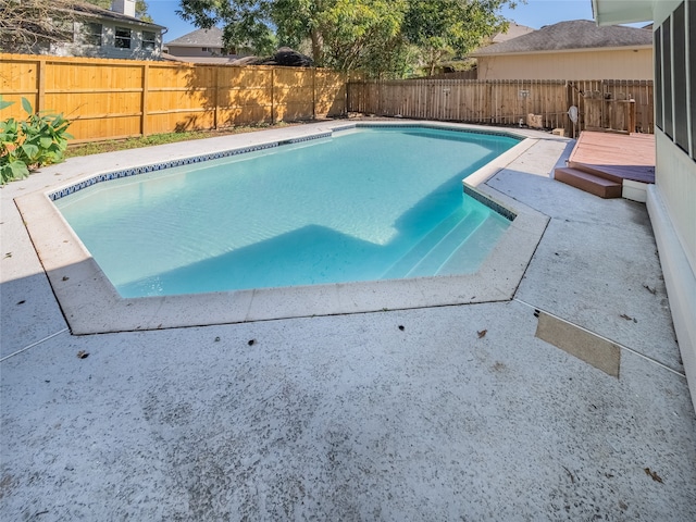 view of swimming pool with a wooden deck