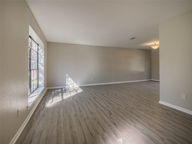 empty room with dark wood-type flooring