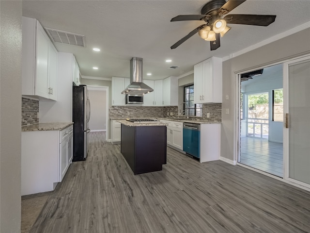 kitchen with white cabinetry, stainless steel appliances, ventilation hood, a kitchen island, and light wood-type flooring