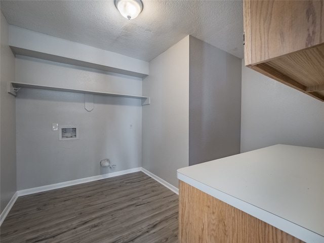 laundry room with a textured ceiling, washer hookup, and dark hardwood / wood-style floors