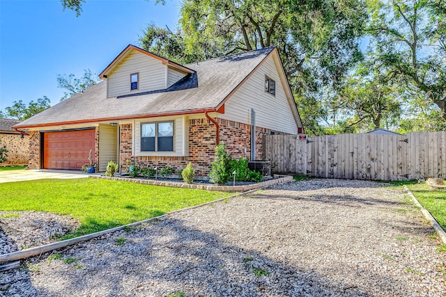 view of front of home featuring a front yard and a garage