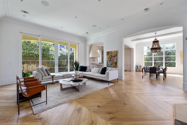 living room featuring light parquet floors and crown molding