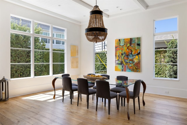 dining area featuring a wealth of natural light, beamed ceiling, and light hardwood / wood-style floors