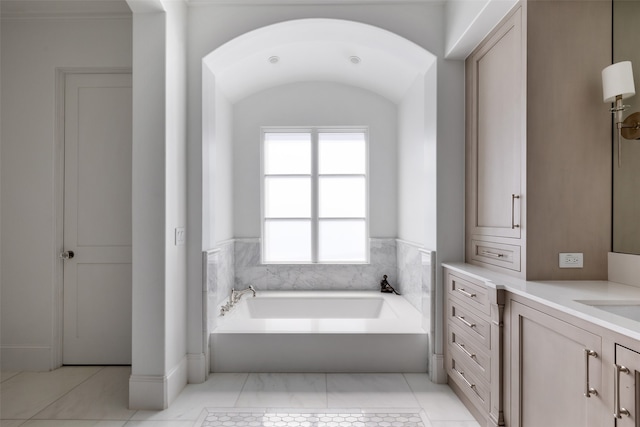 bathroom featuring tile patterned flooring, vanity, and a tub