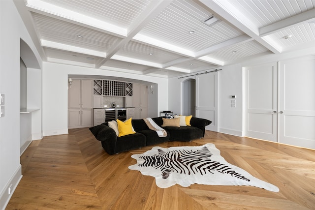 living room featuring bar area, light parquet floors, beamed ceiling, and coffered ceiling