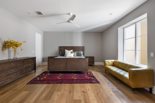 bedroom with ceiling fan and light hardwood / wood-style flooring