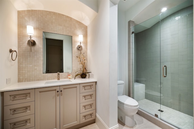 bathroom with vanity, tile patterned flooring, toilet, walk in shower, and tile walls