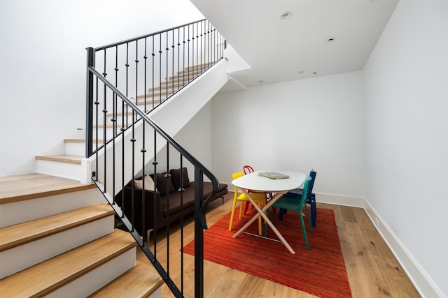 stairs featuring hardwood / wood-style floors