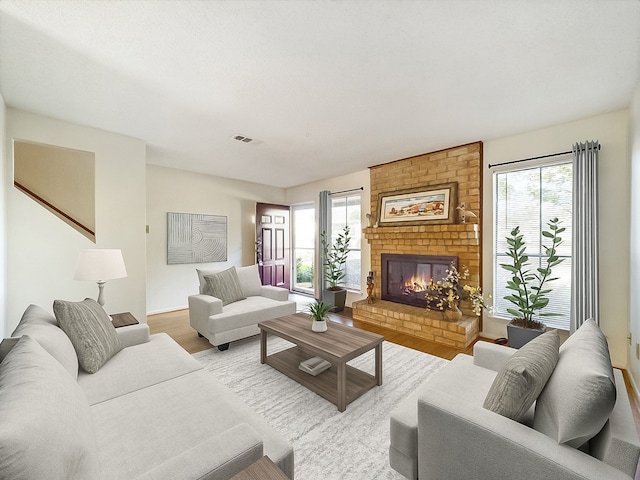 living room featuring a fireplace and light wood-type flooring