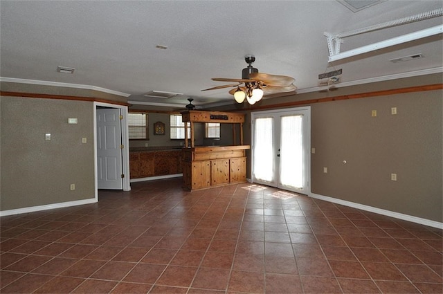 unfurnished living room featuring french doors, a textured ceiling, ceiling fan, crown molding, and dark tile patterned flooring