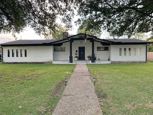 ranch-style house with a front lawn