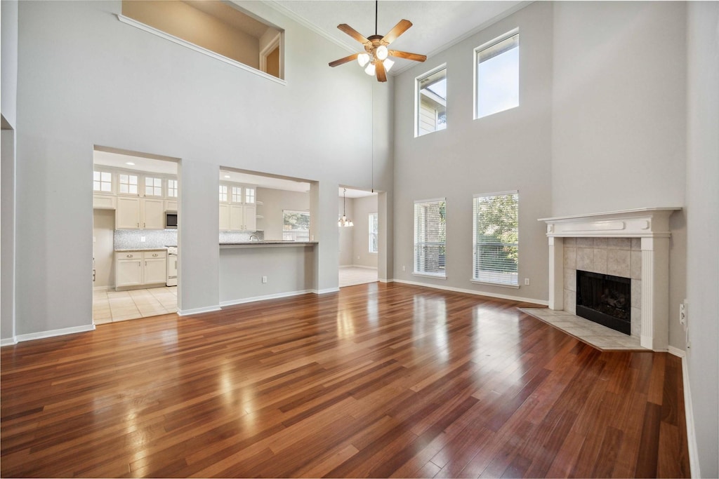 living room featuring a fireplace, a high ceiling, and plenty of natural light