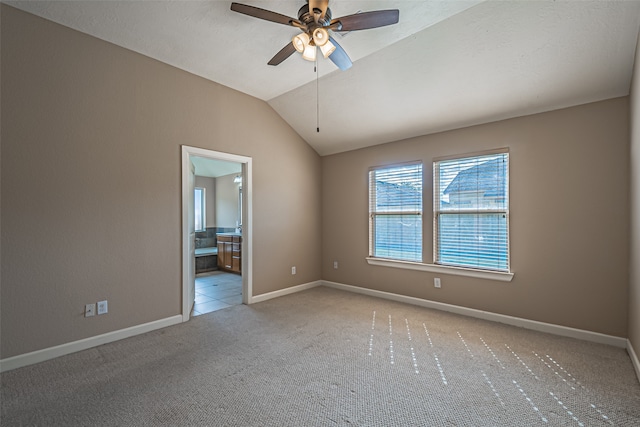 unfurnished room featuring ceiling fan, light carpet, and vaulted ceiling