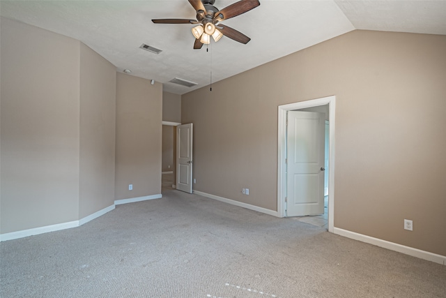 carpeted spare room with ceiling fan and lofted ceiling