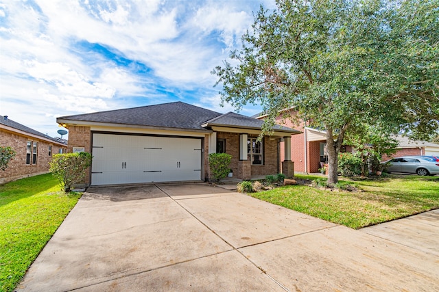 view of front of home with a front yard and a garage