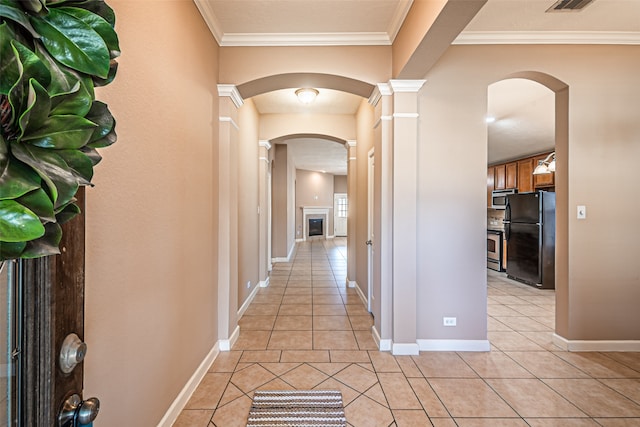 hall featuring crown molding and light tile patterned flooring