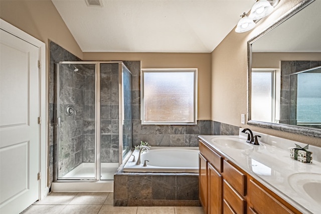 bathroom with tile patterned flooring, vanity, shower with separate bathtub, and vaulted ceiling