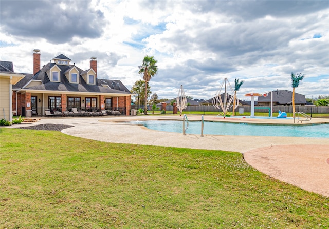 view of pool with a yard and a patio