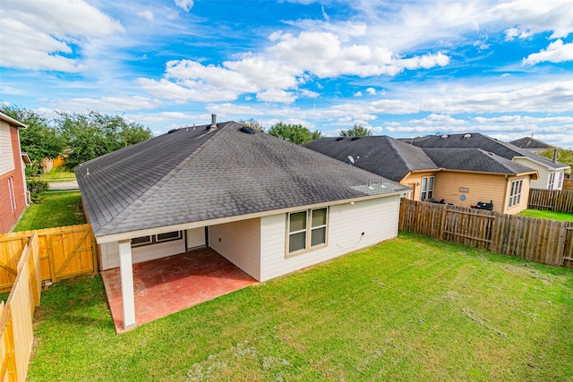 back of house with a lawn and a patio area