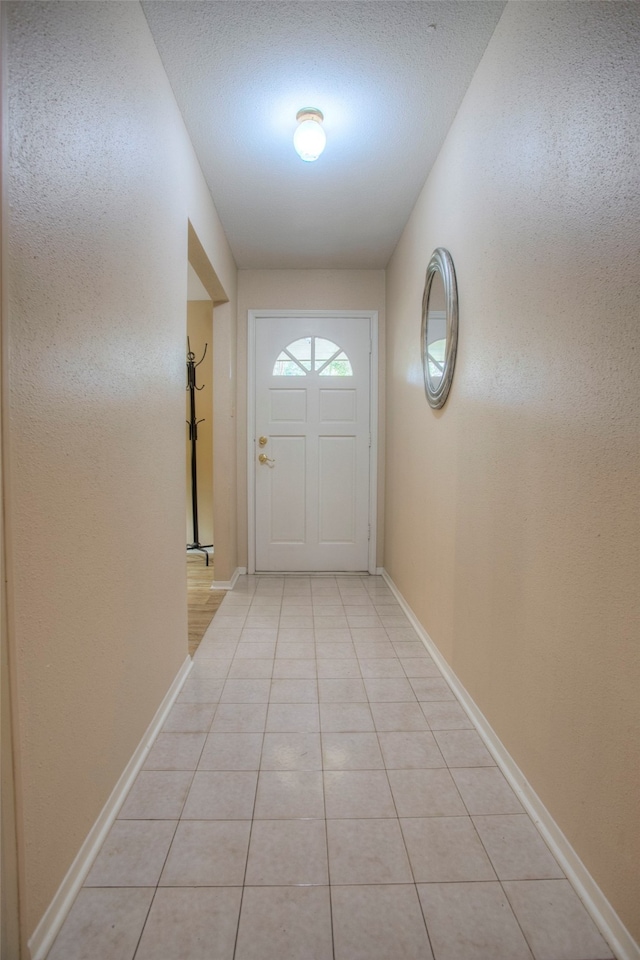 doorway to outside featuring light tile patterned floors