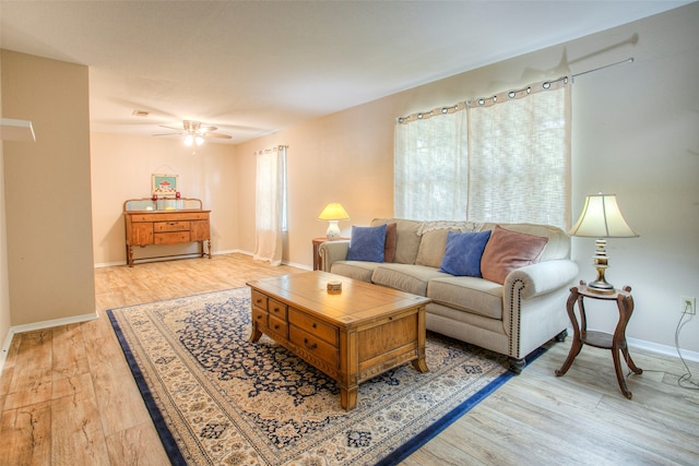 living room featuring light hardwood / wood-style floors and ceiling fan