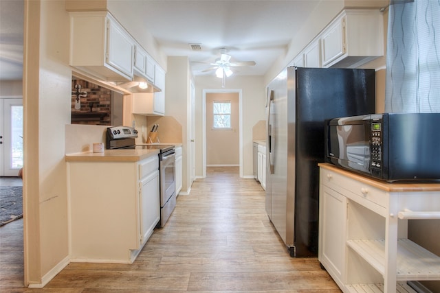 kitchen with white cabinets, stainless steel appliances, and a wealth of natural light