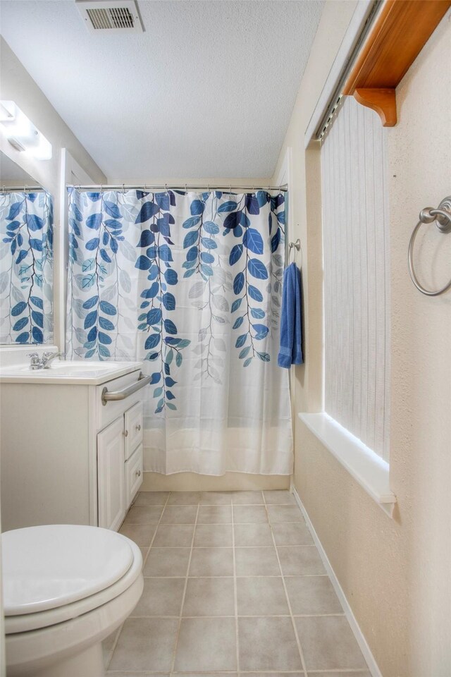 full bathroom featuring toilet, shower / tub combo, vanity, and tile patterned floors