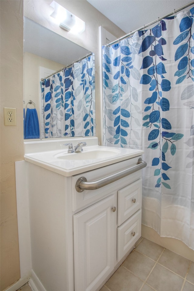 bathroom with tile patterned floors and vanity