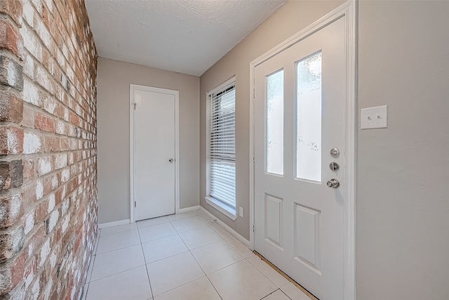 tiled foyer entrance with a textured ceiling