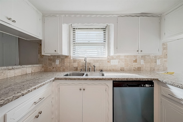 kitchen featuring backsplash, white cabinetry, sink, and stainless steel dishwasher