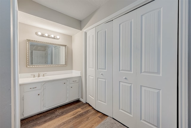 bathroom featuring vanity and hardwood / wood-style flooring