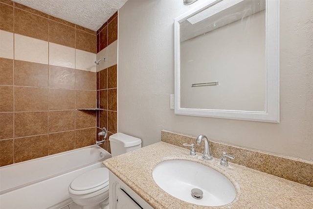 full bathroom with vanity, a textured ceiling, toilet, and tiled shower / bath