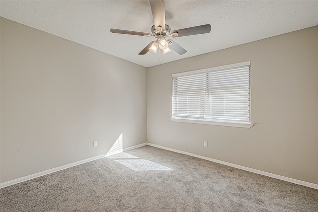 carpeted empty room with ceiling fan and a textured ceiling