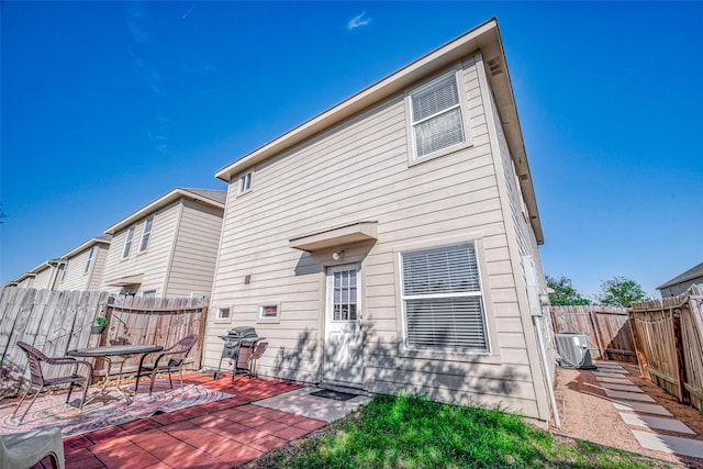 back of property featuring a patio and cooling unit