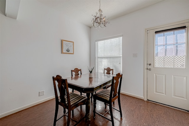 dining room featuring hardwood / wood-style floors, a notable chandelier, and a wealth of natural light