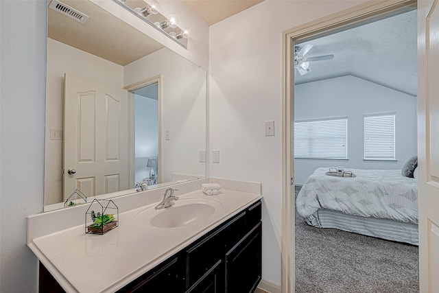 bathroom with vanity, ceiling fan, and lofted ceiling