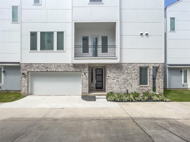 view of property with a balcony and a garage