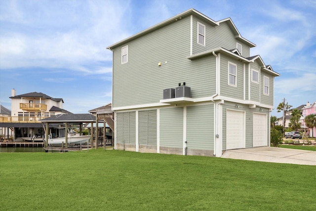 back of property with a lawn and a garage