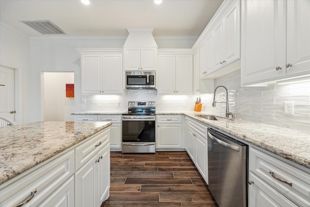 kitchen with white cabinets, sink, crown molding, dark hardwood / wood-style flooring, and stainless steel appliances