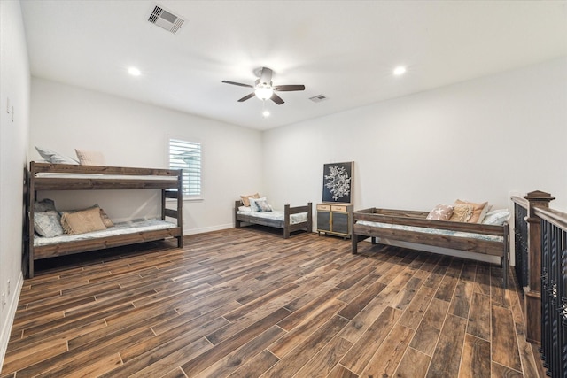 bedroom with dark hardwood / wood-style floors and ceiling fan