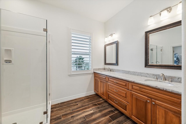 bathroom with hardwood / wood-style floors, vanity, and an enclosed shower