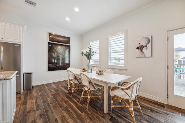 dining room with ornamental molding and dark wood-type flooring