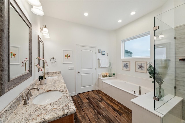 bathroom with vanity, separate shower and tub, and wood-type flooring